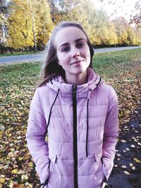 Portrait of smiling young woman standing outdoors