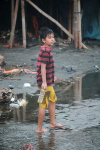 Boy standing in water