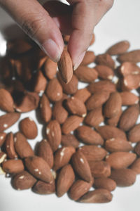 Close-up of hand holding coffee beans