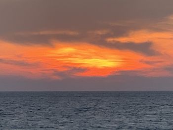 Scenic view of sea against orange sky