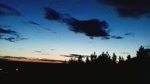 Silhouette of landscape against cloudy sky