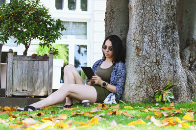 Side view of woman sitting on field