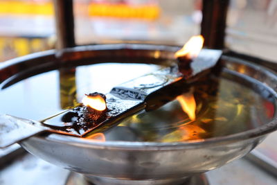 Close-up of burning candles on barbecue grill