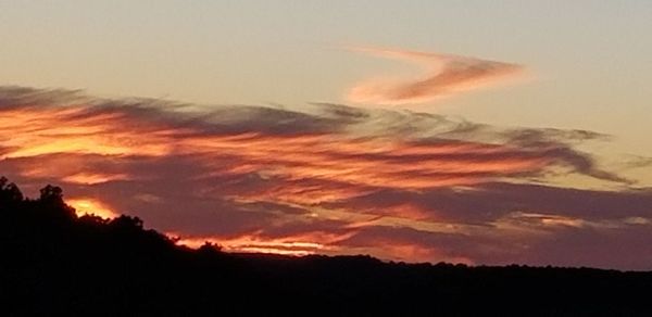 Low angle view of dramatic sky during sunset