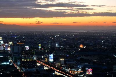 High angle view of illuminated buildings against sky during sunset