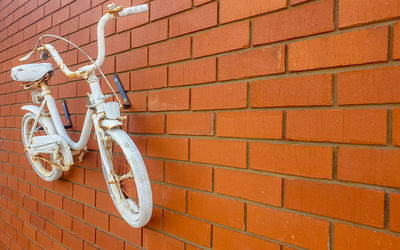 Close-up of bicycle on brick wall