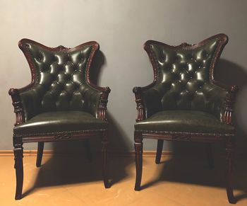 Close-up of chairs on table at home