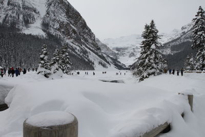 Panoramic view of people on snow covered landscape