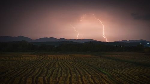 Scenic view of field against sky at night