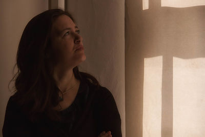 Thoughtful woman looking at wall