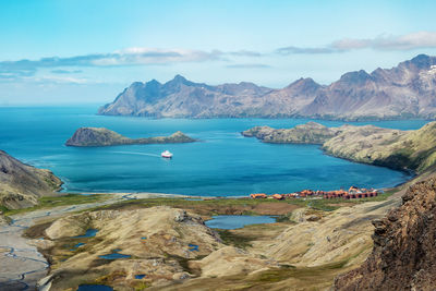 Panoramic view of sea and mountains against sky