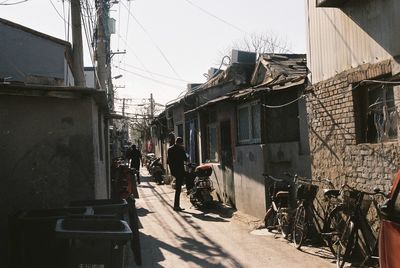 People on street amidst buildings in city