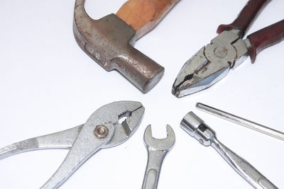 High angle view of chain and pen against white background