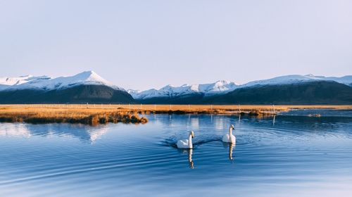 Scenic view of lake and mountains against sky