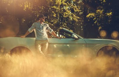 Full length of man standing by car