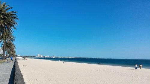 View of beach against clear blue sky