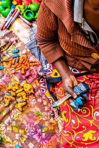 Low section of woman working in multi colored pencils