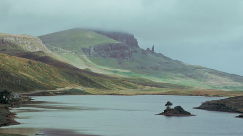 Scenic view of sea and mountains against sky