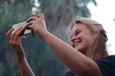 Woman photographing on mobile phone