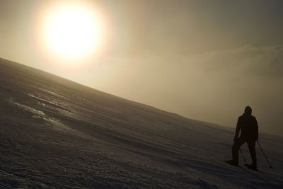 Rear view of man on landscape against sky