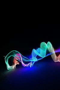 Close-up of light painting against black background