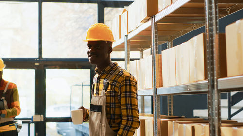 Rear view of man standing in factory