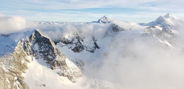 Scenic view of snow covered mountains against sky