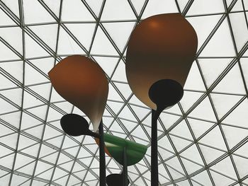 Low angle view of illuminated pendant lights on ceiling