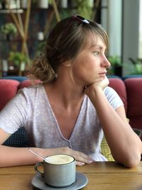 Young woman drinking glasses on table at cafe