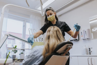 Female dentist with patient in dentist's office