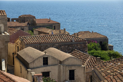 High angle view of townscape by sea against sky