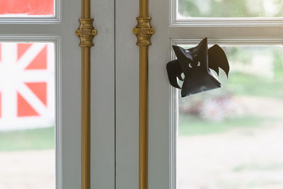 Origami bat made of black paper hanging on a rope for halloween decorations. 
