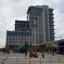 Buildings against cloudy sky