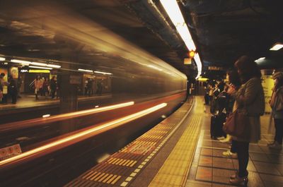 People at railroad station at night