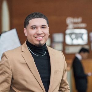 Portrait of young man standing indoors at event