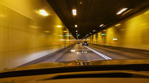 Illuminated blur tunnel seen through car windshield