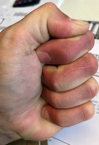 Close-up of father holding baby hand