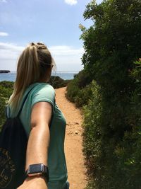 Woman on pathway against sky