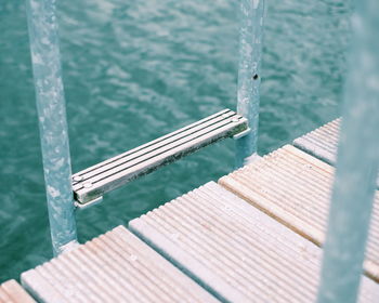 High angle view of ladder on pier over lake