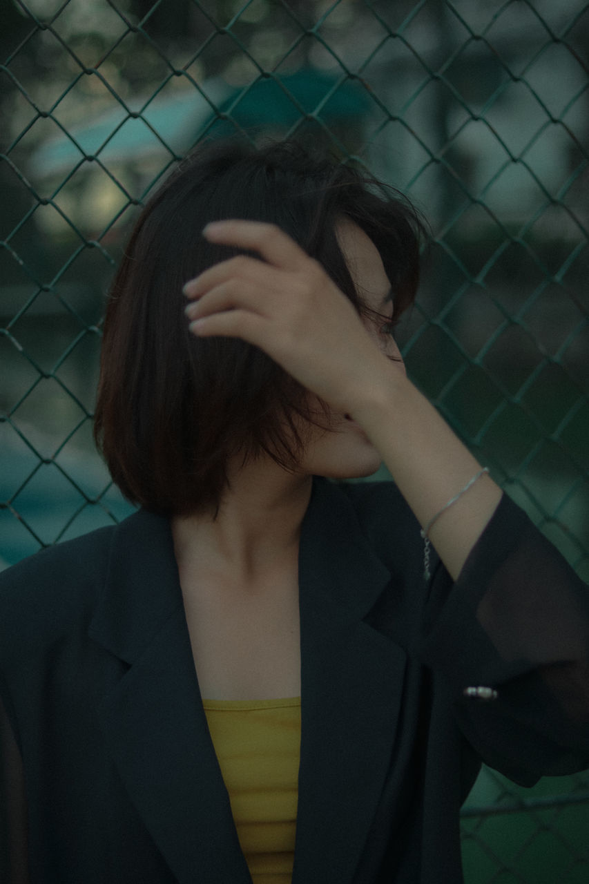 PORTRAIT OF YOUNG WOMAN WITH ARMS HAIR