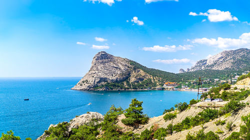 Scenic view of bay against blue sky