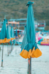 Close-up of multi colored umbrellas hanging on beach