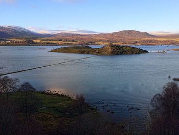 Scenic view of lake and mountains against clear sky