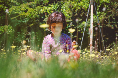 Close-up of girl with flowers in park