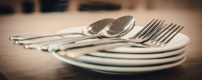 Close-up of eating utensils on table