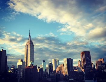 View of skyscrapers against cloudy sky