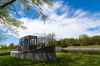 Built structure by lake against sky