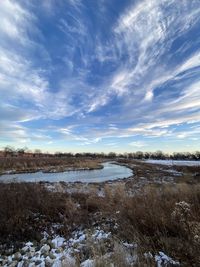 Scenic view of frozen lake against sky