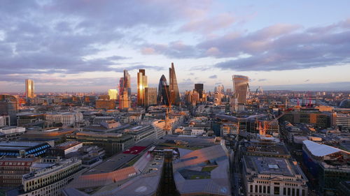 High angle view of buildings against cloudy sky