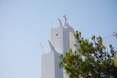 Low angle view of chapel and tree against clear blue sky